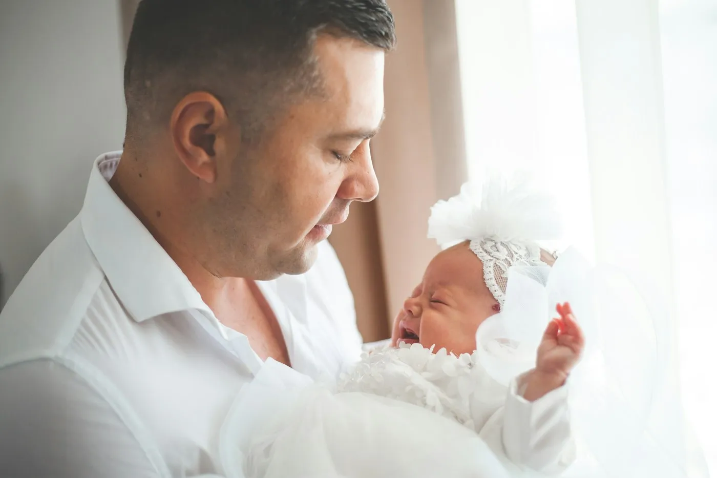 A father looking down at his newborn daughter